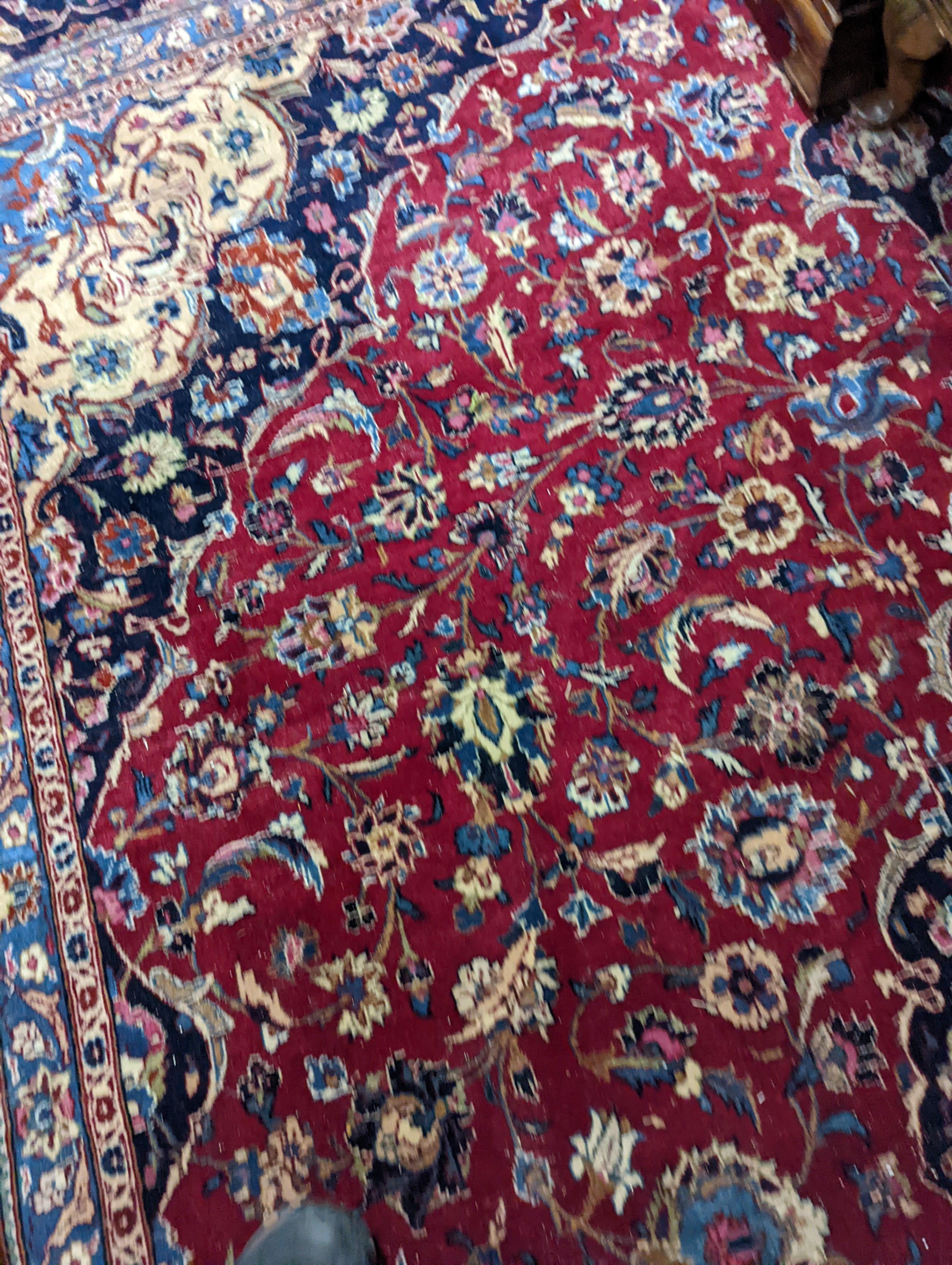 A Kashan burgundy ground carpet, 380 x 300cm